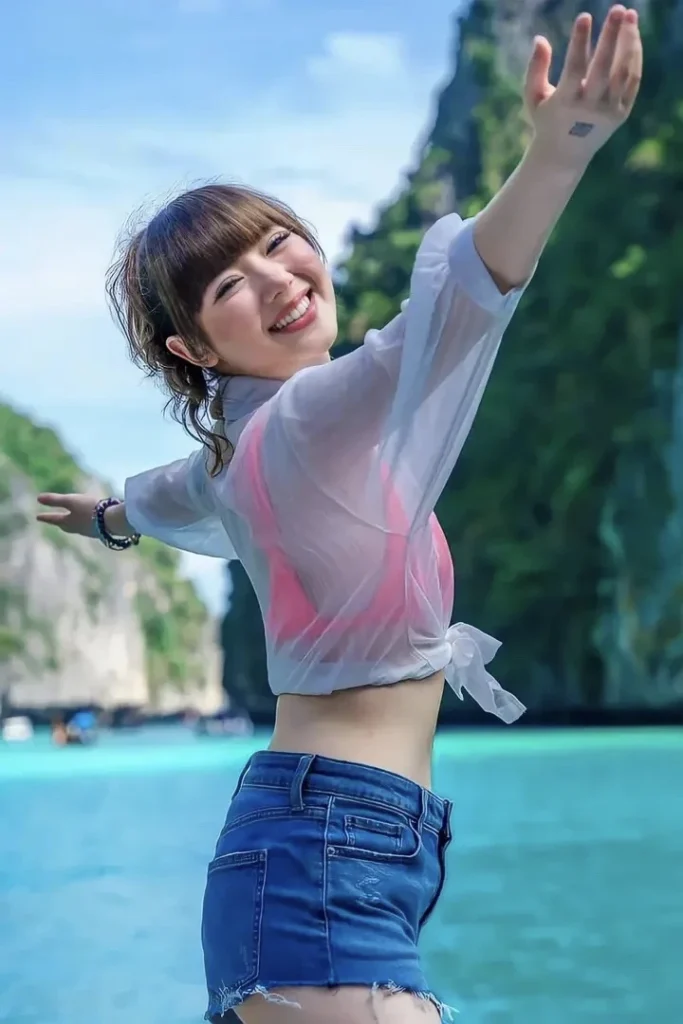 cute thai girl Jannine Weigel with short, posing outdoor and smiling