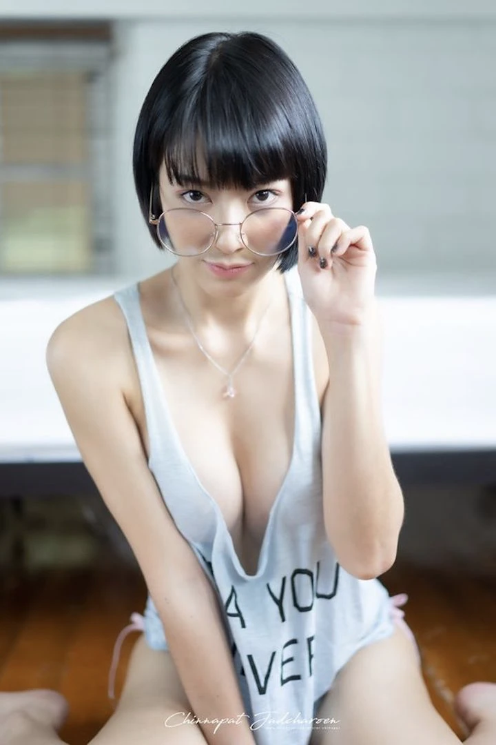 beautiful Thai girl Fangko Chatkamon holding her glasses and showing her boobs to the camera