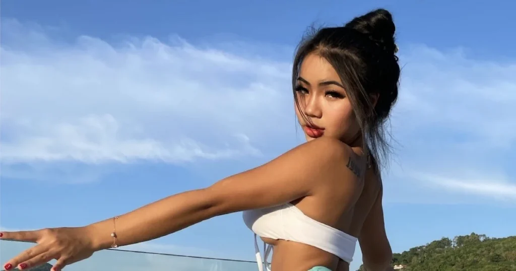 model Praew Phatcharin wearing a white bikini on a boat