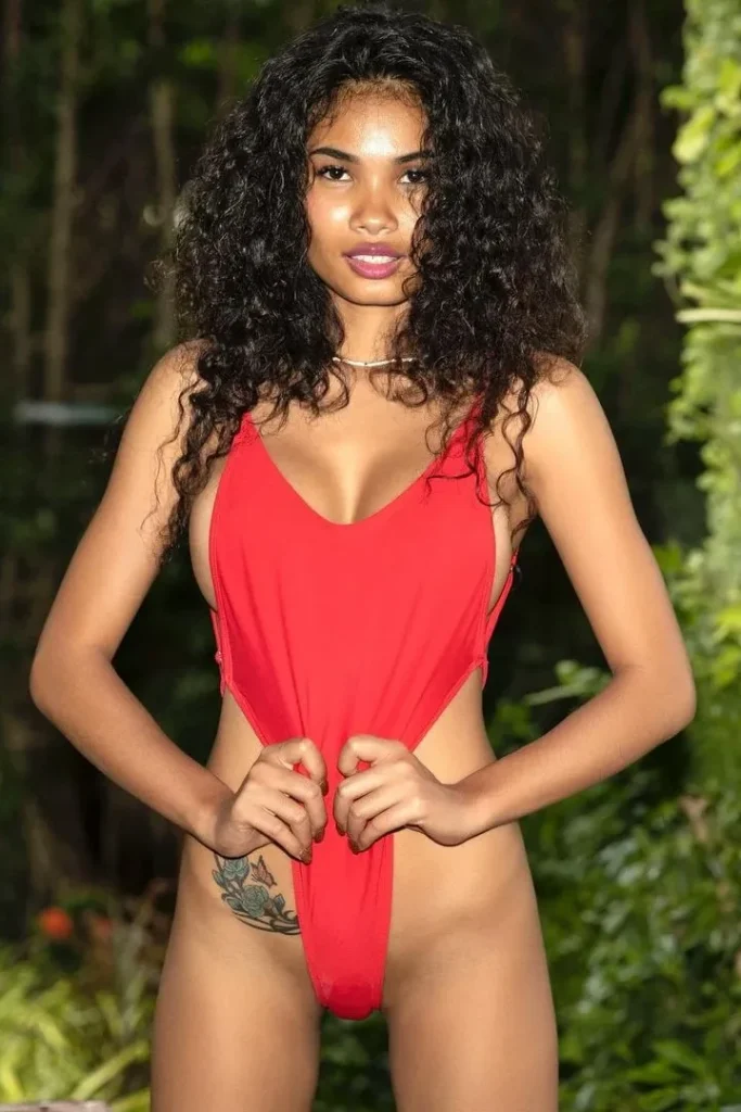 The superb Thai model Manirat with a tattoo on the hip in a sexy red bikini.