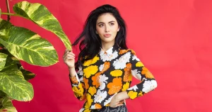 Thai girl Davika Hoorne posing with a flowers shirt on pink background