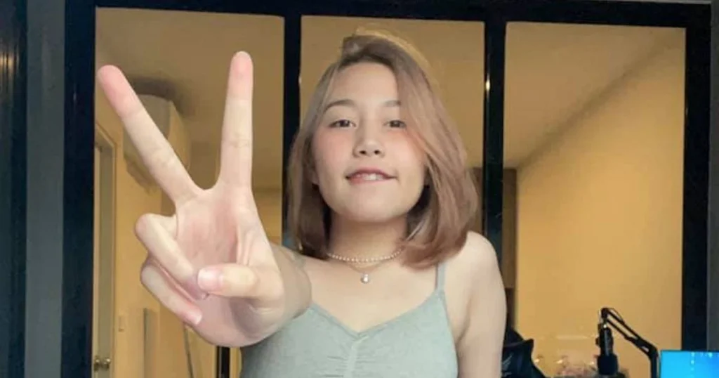 Thai girl Kainaoa doing a V sign