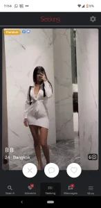 a sexy thai girl in a tight dress is taking a selfie to find a man on seeking