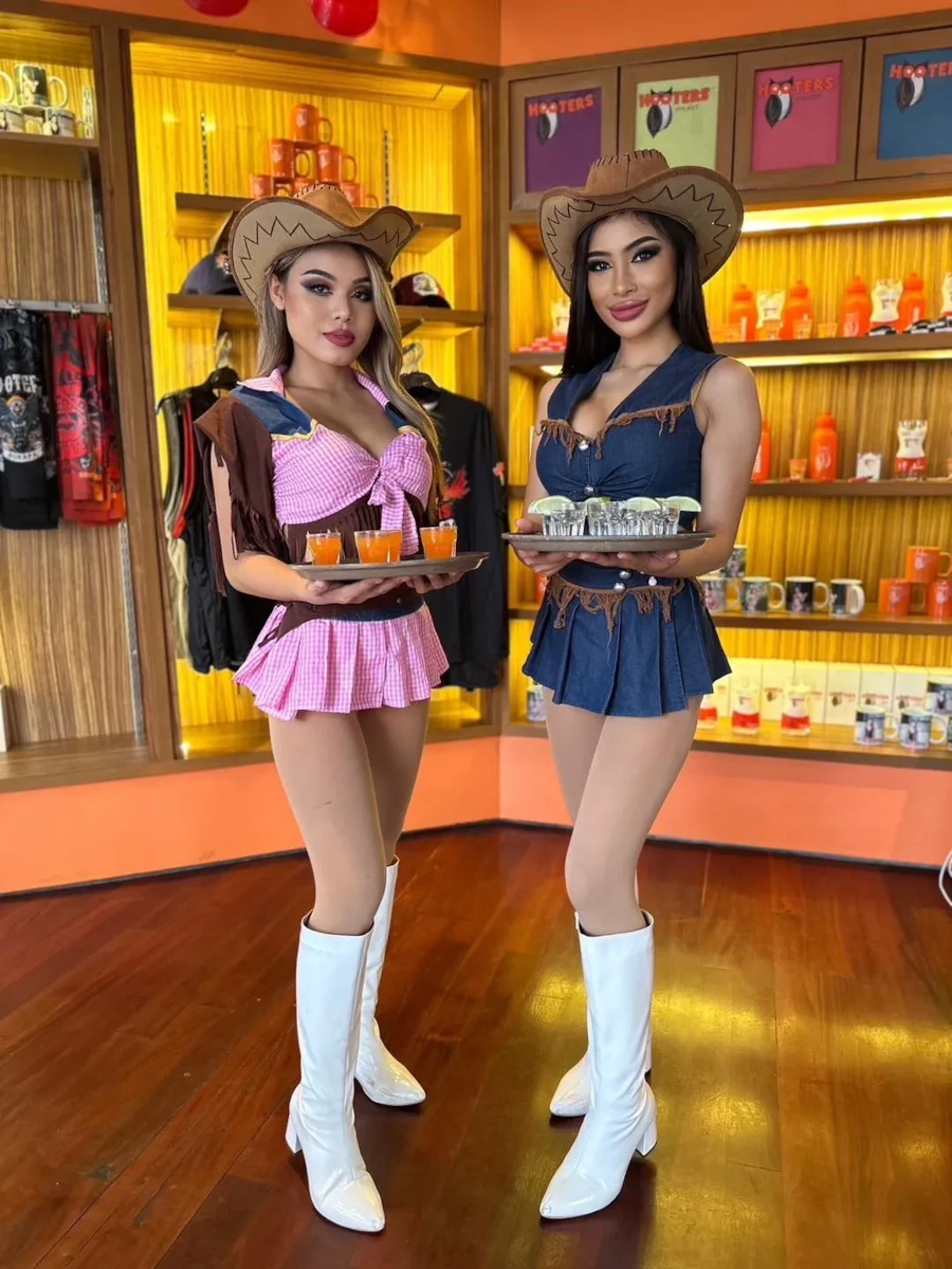 Two very hot girls posing with cowboy outfit at Hooters Bangkok.