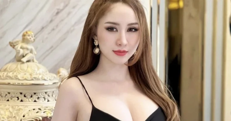 beautiful Thai model Yumiko Miyaki in a black dress a with a big cleavage